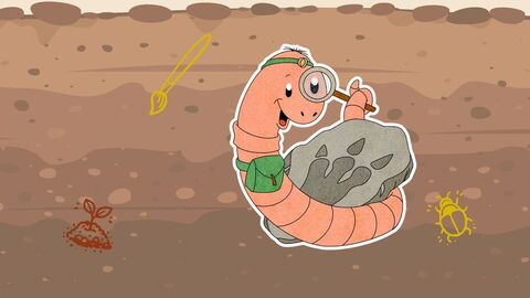 Grafik von einem Comic-Regenwurm, der sich eine Lupe vor ein Auge hält und ein Fossil umkreist.